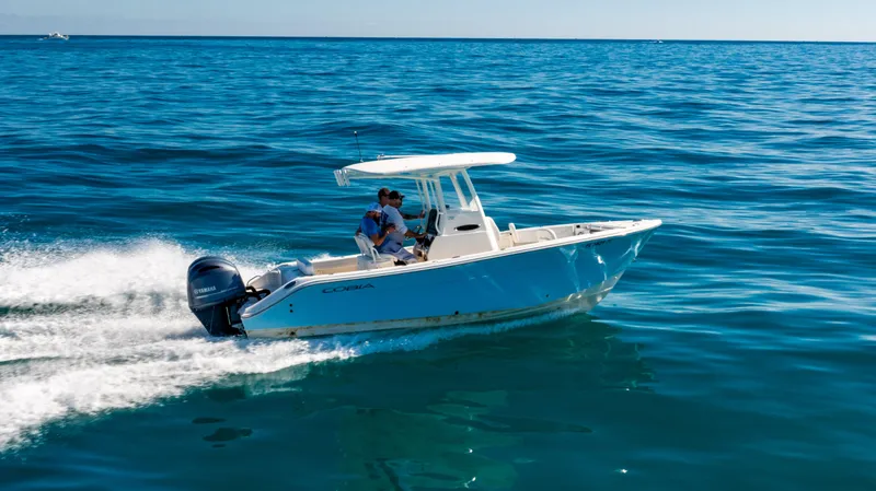 Slide: The Image of 2022 Cobia 240 CC boat cruising on open blue ocean waters. - 27