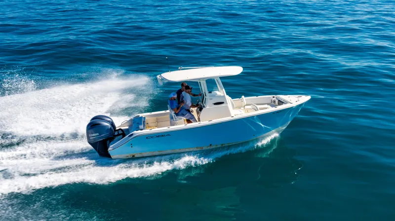 Slide: The Image of 2022 Cobia 240 CC boat cruising on open water, showcasing sleek design and powerful engine. - 28