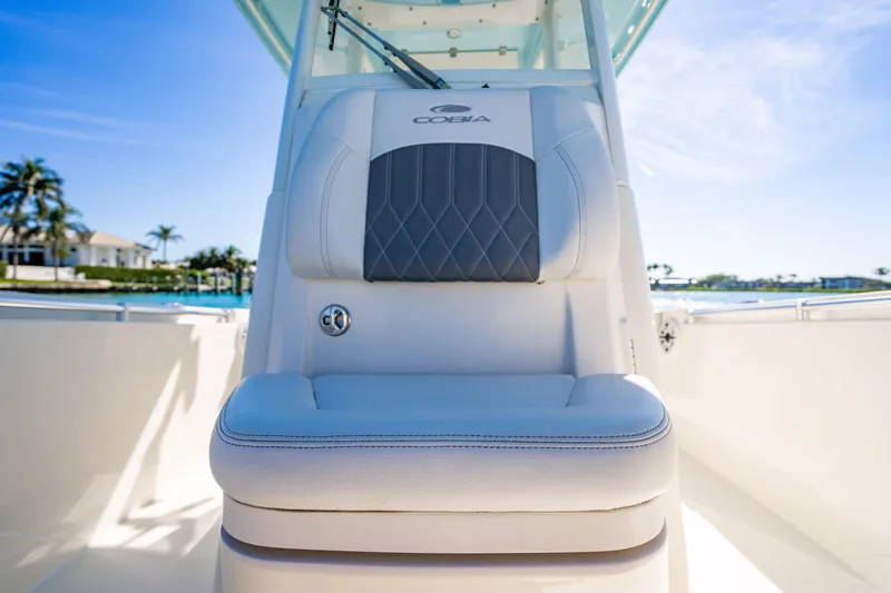 Slide: The Image of 2022 Cobia 240 CC boat seat with elegant design and waterfront view. - 5