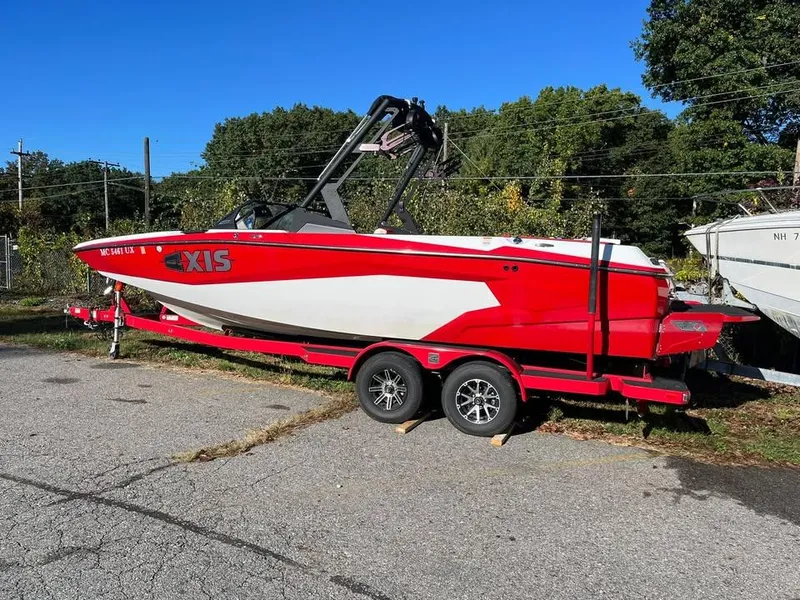 Slide: The Image of Red 2023 Axis A225 boat on trailer, parked outdoors on a sunny day. - 3