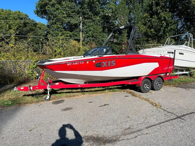 Slide: The Image of 2023 Axis A225 boat on trailer, red and white design, parked outdoors. - 4