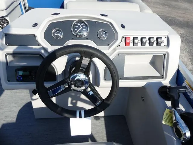 Slide: The Image of 2025 Godfrey Pontoons Xperience 1886 CX dashboard with steering wheel and control panel. - 10