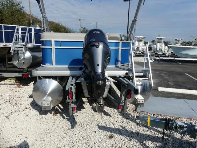 Slide: The Image of 2025 Godfrey Pontoons Xperience 1886 CX, blue pontoon boat, rear view with motor. - 6