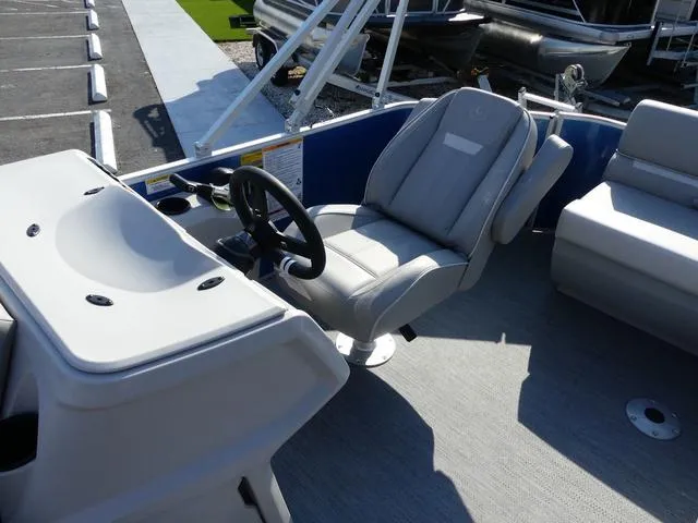 Slide: The Image of 2025 Godfrey Pontoons Xperience 1886 CX interior with steering wheel and seating. - 7