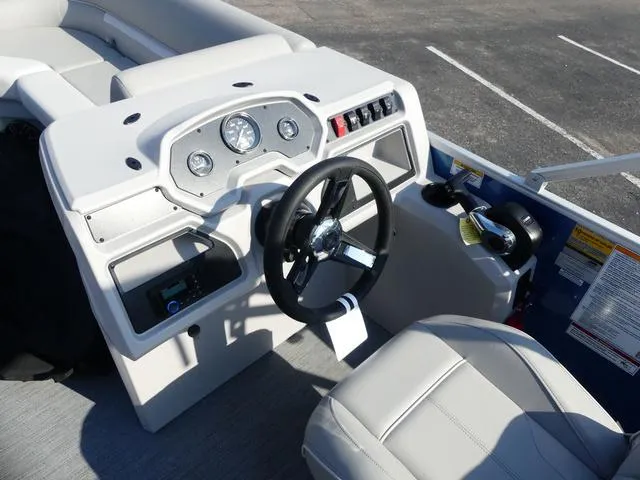 Slide: The Image of 2025 Godfrey Pontoons Xperience 1886 CX dashboard with steering wheel and controls. - 9