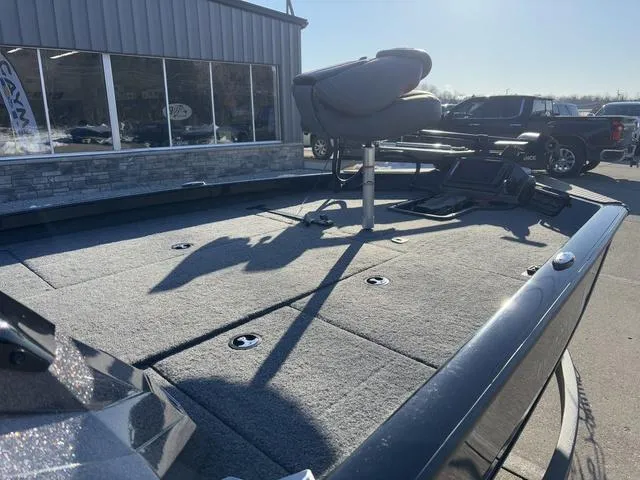 Slide: The Image of 2023 Ranger RT188 boat deck with seating and equipment, parked outside a building. - 6