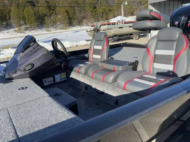 Slide: The Image of 2023 Ranger RT188 boat interior with gray and red seating, snowy background. - 9