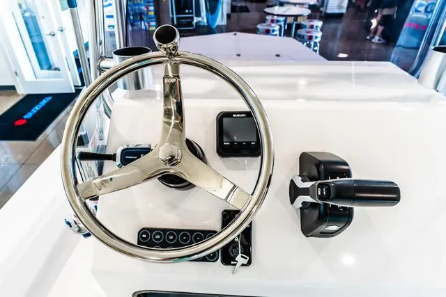 Slide: The Image of 2025 Majek 18 M2 boat dashboard with steering wheel and controls. - 10