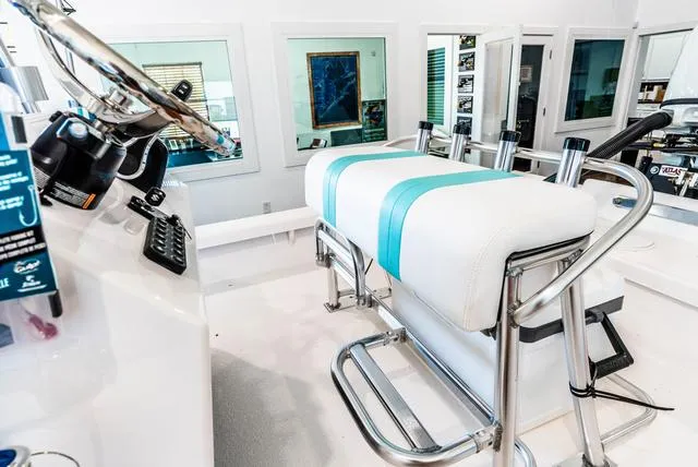 Slide: The Image of 2025 Majek 18 M2 boat interior with steering wheel and cushioned seating. - 11