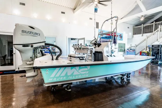 Slide: The Image of 2025 Majek 18 M2 boat with Suzuki engine displayed indoors. - 13