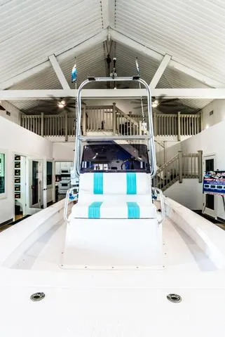 Slide: The Image of 2025 Majek 18 M2 boat displayed indoors with modern design and seating. - 8