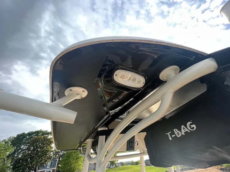 Slide: The Image of 2021 Stingray 216 CC boat underside with T-BAG storage and lighting, against a cloudy sky. - 4