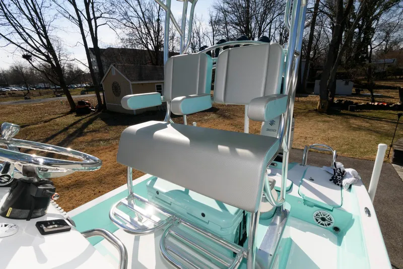 Slide: The Image of 2020 Shallow Sport 24 Modified V boat interior with dual seats and steering wheel. - 10