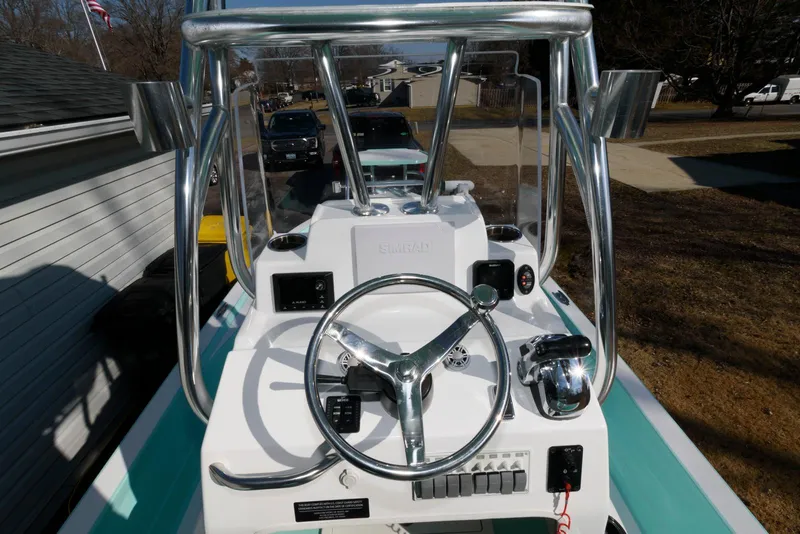 Slide: The Image of 2020 Shallow Sport 24 Modified V boat console with steering wheel and controls. - 12