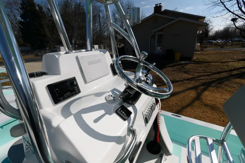 Slide: The Image of 2020 Shallow Sport 24 Modified V boat console with steering wheel and controls. - 13