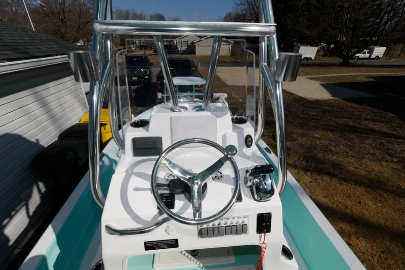 Slide: The Image of 2020 Shallow Sport 24 Modified V boat console with steering wheel and controls. - 14