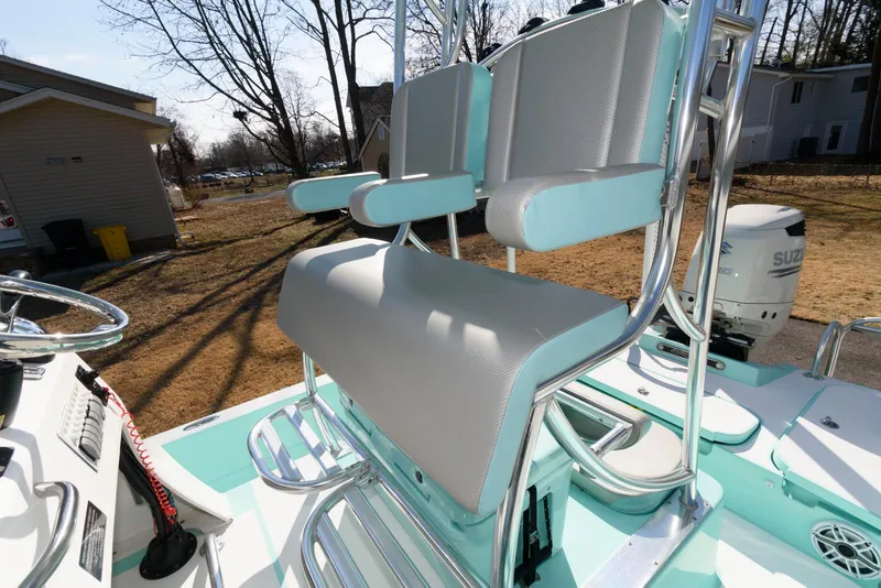 Slide: The Image of 2020 Shallow Sport 24 Modified V boat interior with seating and steering wheel. - 15