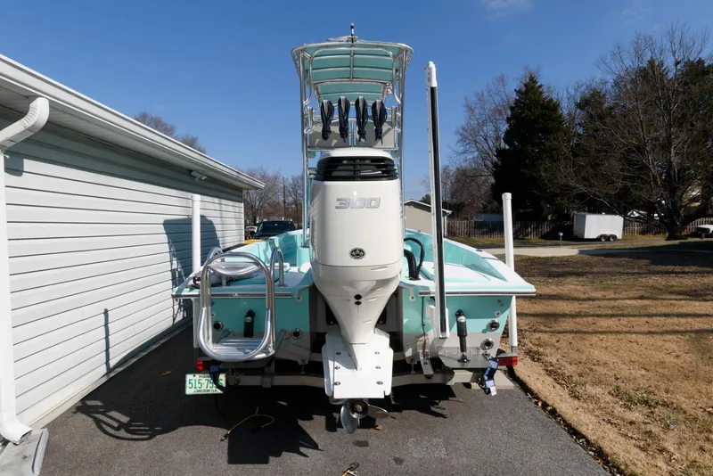 Slide: The Image of 2020 Shallow Sport 24 Modified V boat with powerful outboard motor, parked outdoors. - 3