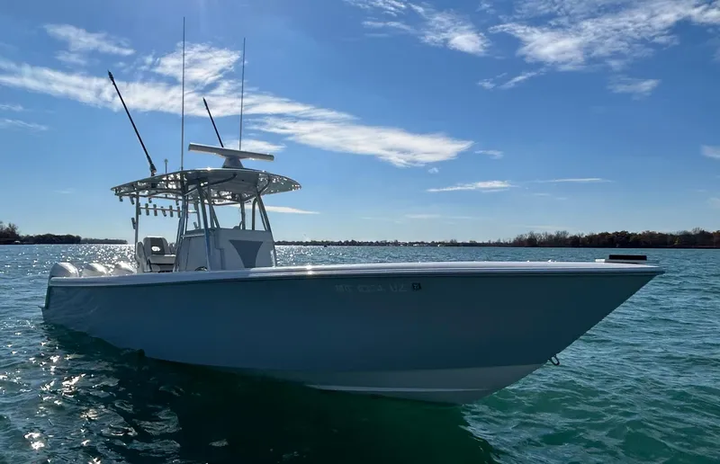 Slide: The Image of 2022 Contender 35 ST boat on calm water under a clear blue sky. - 0