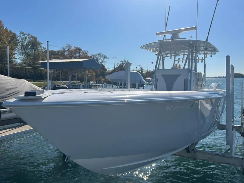 Slide: The Image of 2022 Contender 35 ST boat docked in a marina under clear skies. - 11