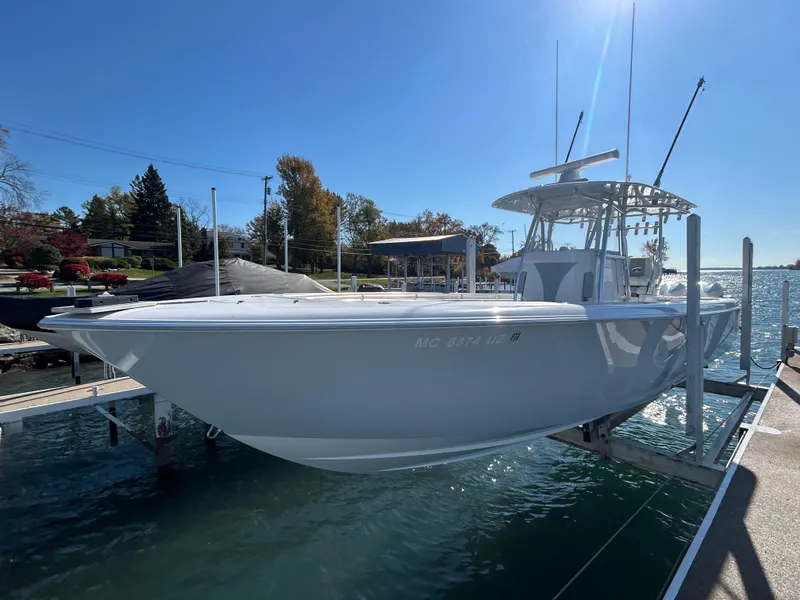 Slide: The Image of 2022 Contender 35 ST boat docked on a sunny day, showcasing sleek design and modern features. - 12