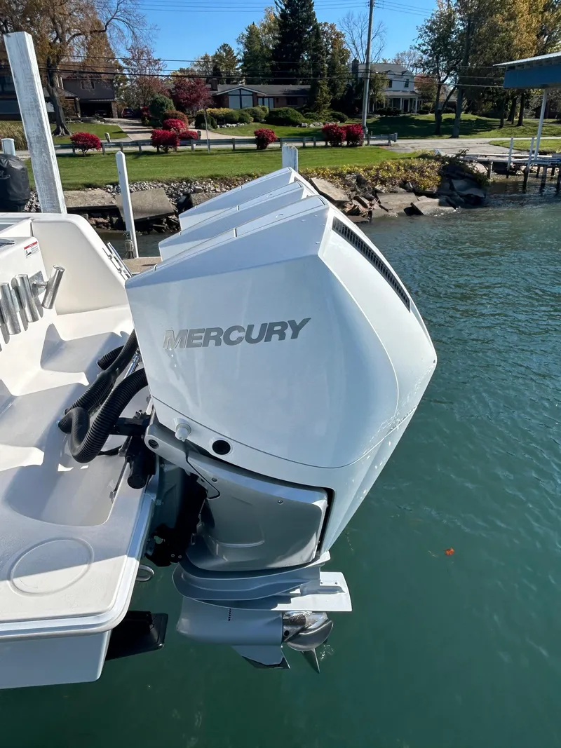 Slide: The Image of 2022 Contender 35 ST boat with Mercury outboard motor on a calm lake. - 13