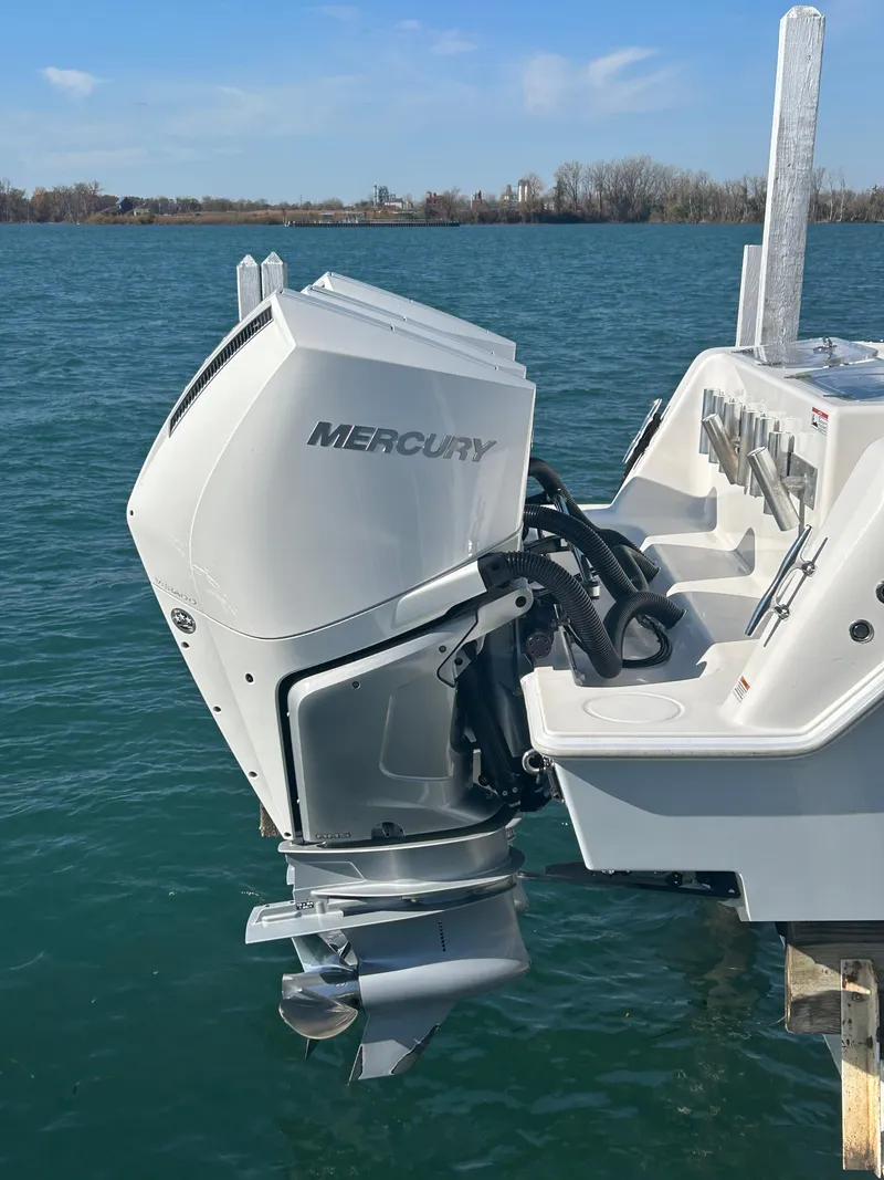 Slide: The Image of 2022 Contender 35 ST boat with Mercury outboard motor on a calm lake. - 14