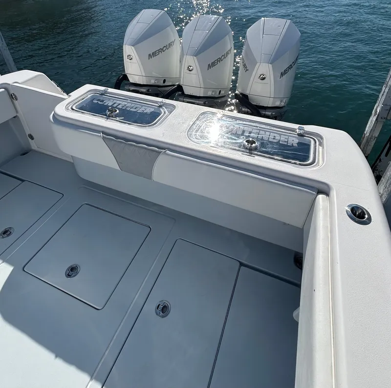Slide: The Image of 2022 Contender 35 ST boat with triple Mercury engines on calm water. - 15