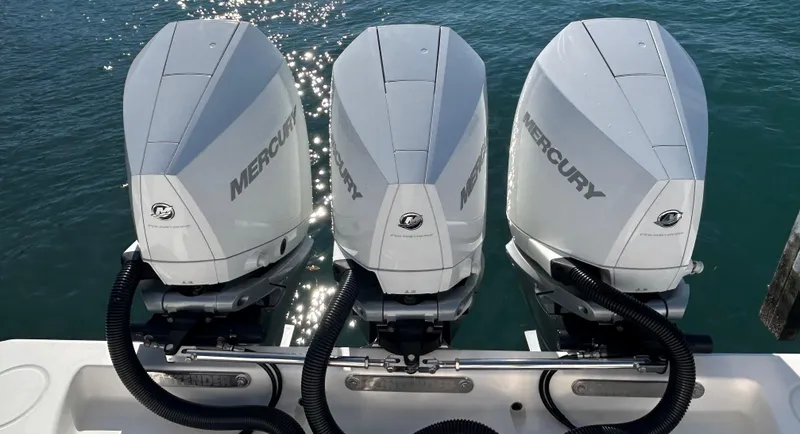 Slide: The Image of Triple Mercury outboard engines on a 2022 Contender 35 ST boat, glistening in sunlight. - 16