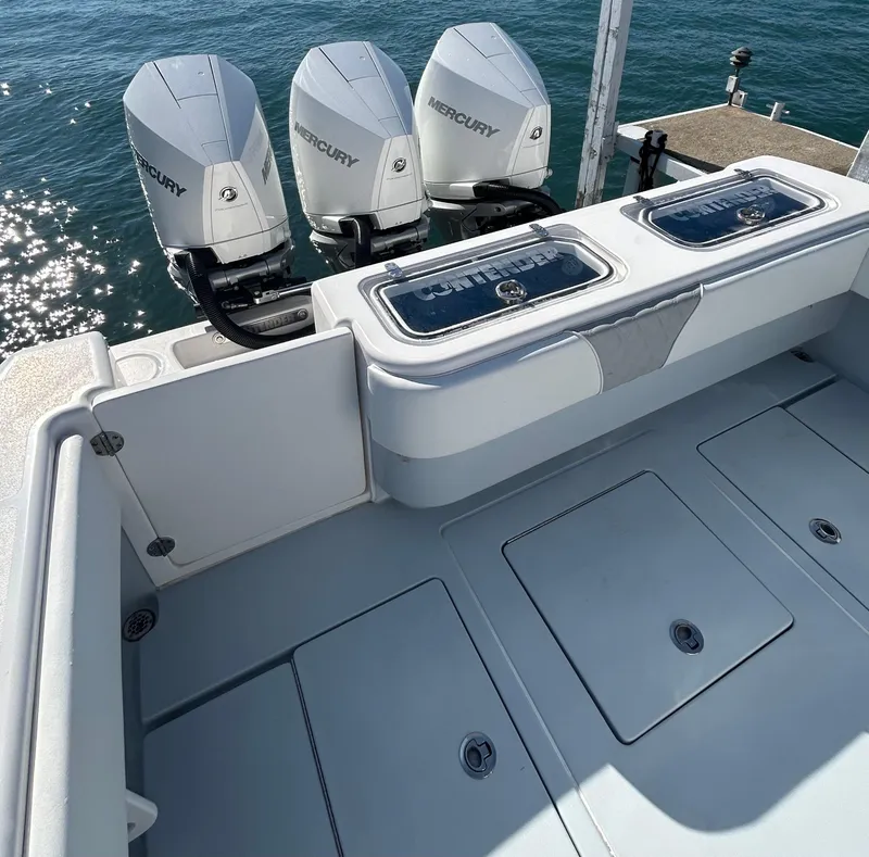 Slide: The Image of 2022 Contender 35 ST boat with triple Mercury engines on a sunny day. - 17