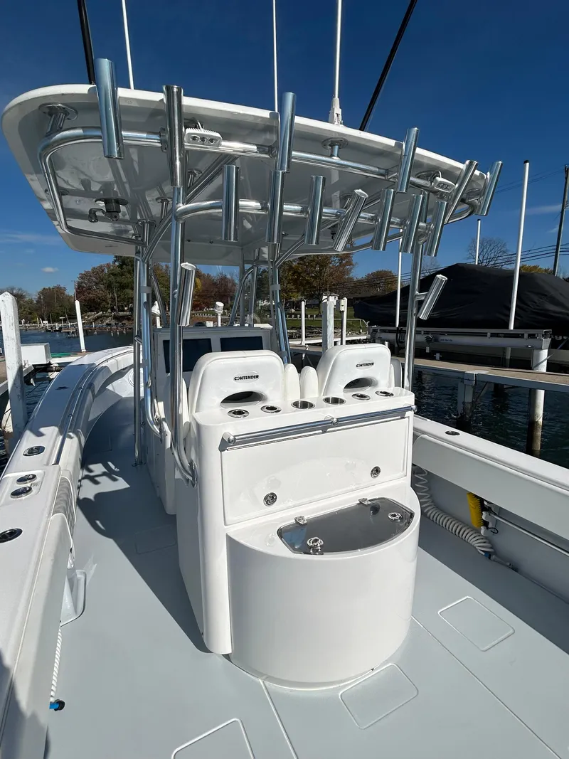 Slide: The Image of 2022 Contender 35 ST boat with T-top and seating, docked at marina. - 18