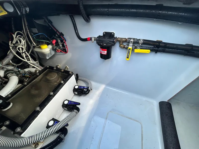Slide: The Image of 2022 Contender 35 ST boat engine compartment with wiring and fuel system components. - 22