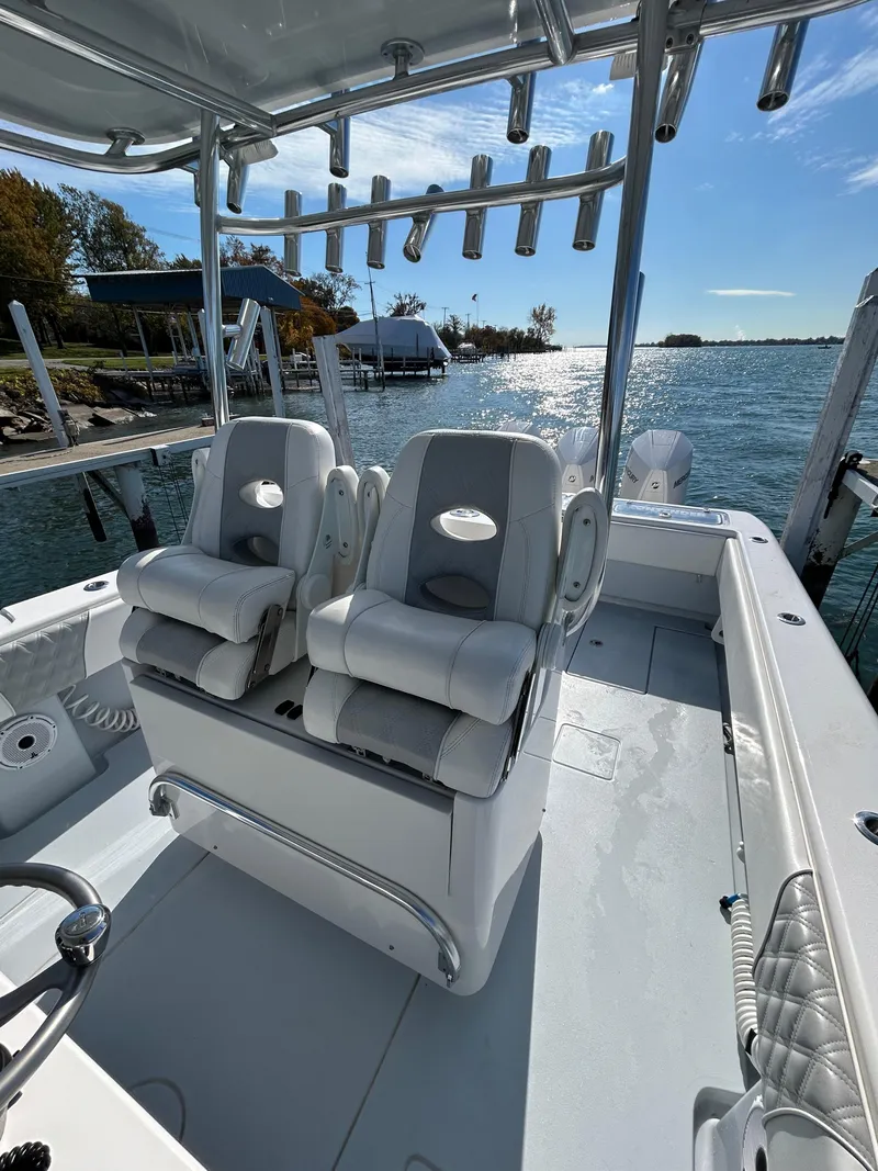 Slide: The Image of 2022 Contender 35 ST boat with dual seats, rod holders, and scenic waterfront view. - 23
