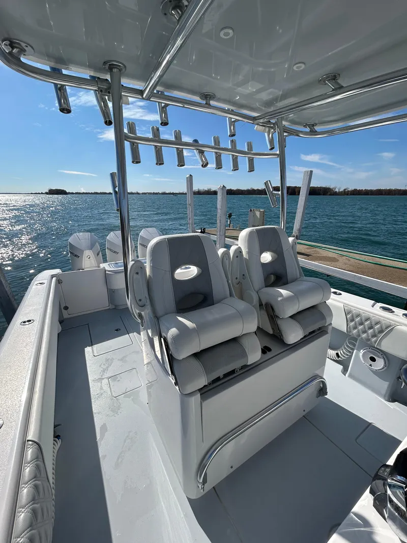 Slide: The Image of 2022 Contender 35 ST boat interior with seating and rod holders, docked by the water. - 24