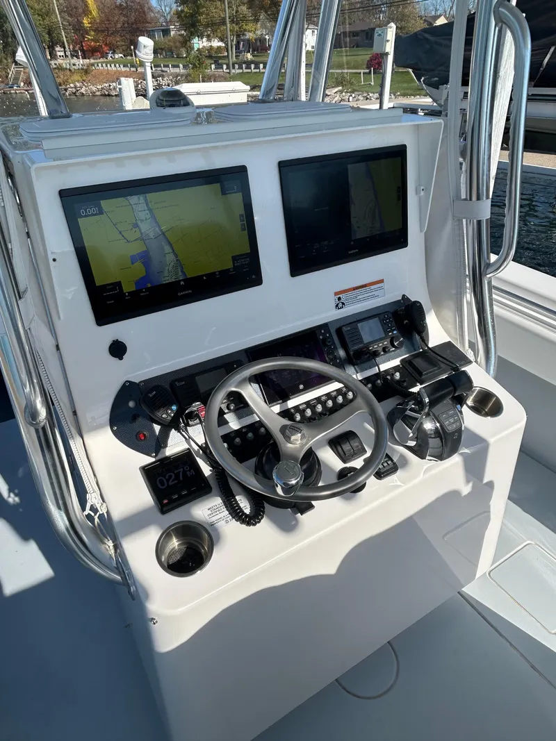 Slide: The Image of 2022 Contender 35 ST boat dashboard with dual screens and steering wheel. - 26