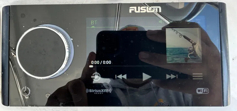 Slide: The Image of Fusion audio system on a 2022 Contender 35 ST boat, displaying media controls. - 31