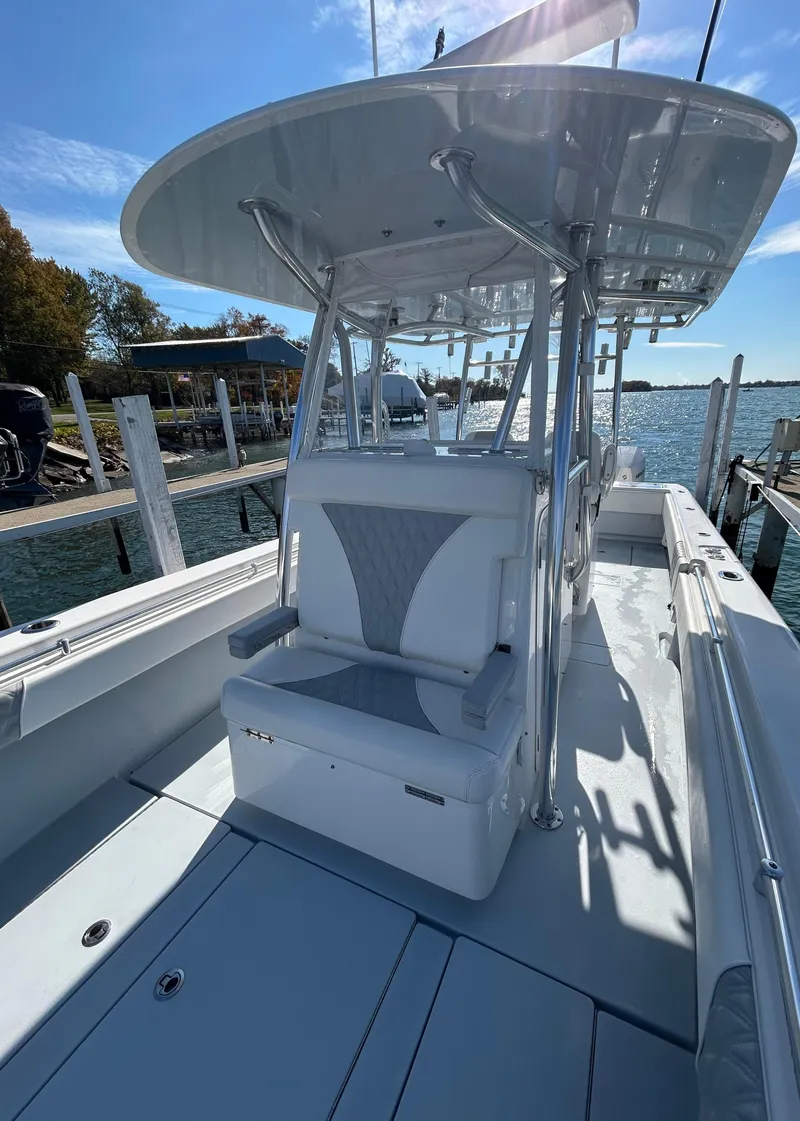 Slide: The Image of 2022 Contender 35 ST boat docked, featuring sleek design and spacious seating. - 38