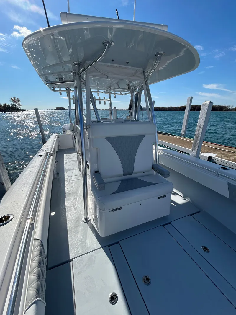 Slide: The Image of 2022 Contender 35 ST boat, sleek design, spacious deck, docked by the water. - 39