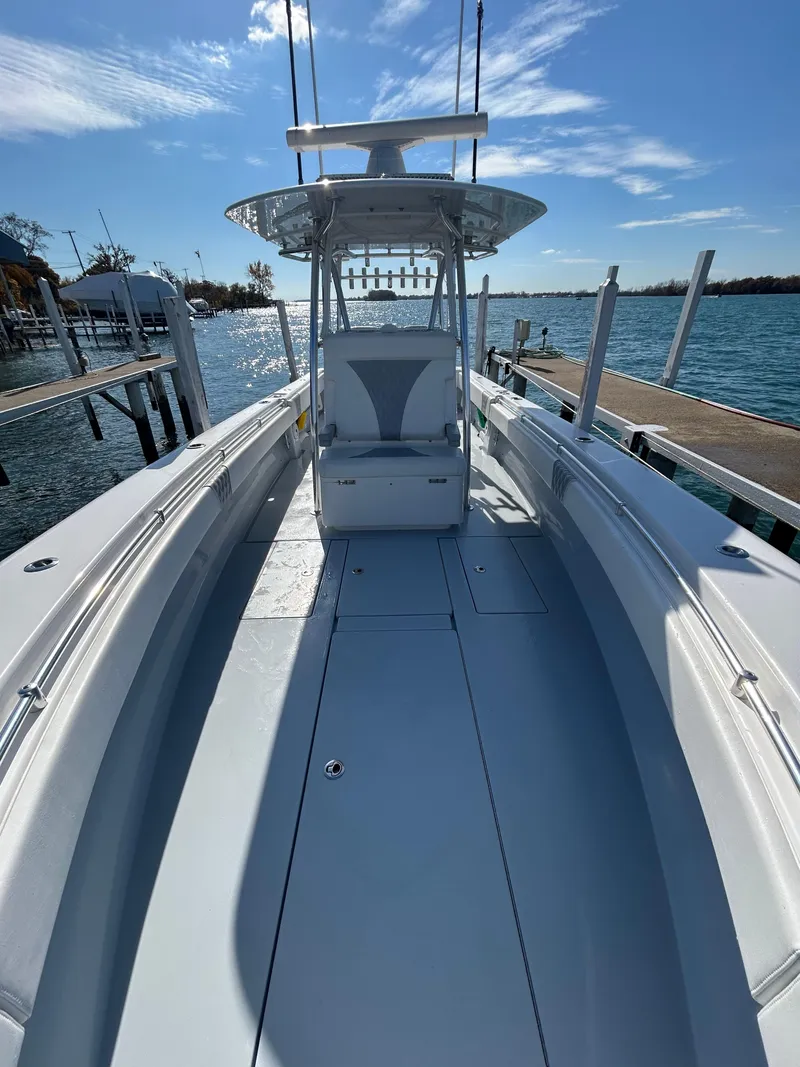 Slide: The Image of 2022 Contender 35 ST boat docked by the water under a clear blue sky. - 40