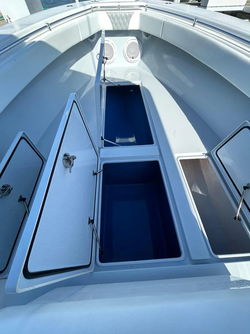 Slide: The Image of 2022 Contender 35 ST boat with open storage compartments and sleek design. - 41
