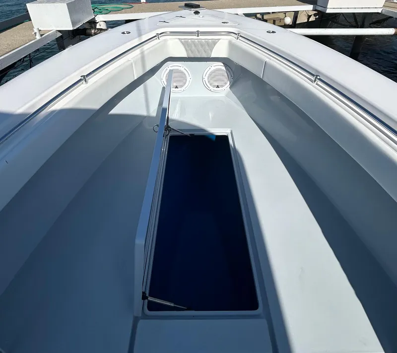 Slide: The Image of 2022 Contender 35 ST boat interior with storage compartment open. - 42
