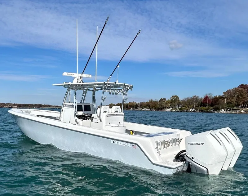 Slide: The Image of 2022 Contender 35 ST boat with twin Mercury engines on a calm lake. - 6