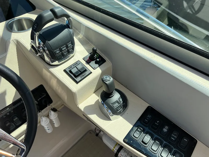 Slide: The Image of Control panel of a 2021 Regal 33 Express boat, featuring throttle and joystick controls. - 11