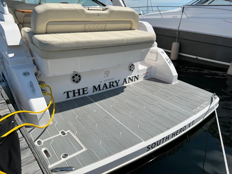 Slide: The Image of 2021 Regal 33 Express boat docked, featuring spacious deck and seating. - 2