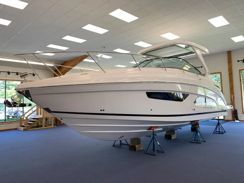 Slide: The Image of 2021 Regal 33 Express boat displayed indoors on stands. - 21
