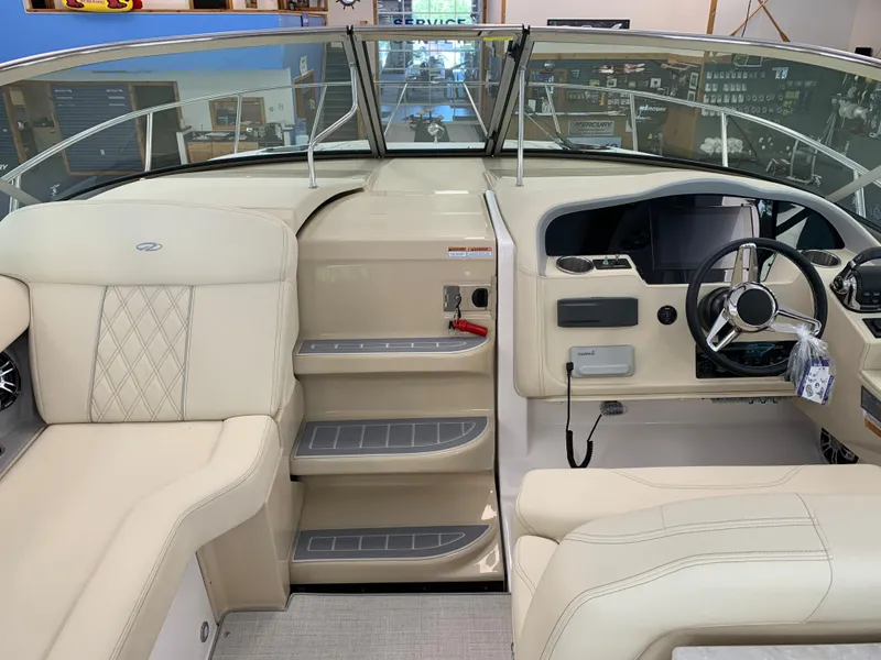 Slide: The Image of 2021 Regal 33 Express boat interior with beige seating and modern helm controls. - 28