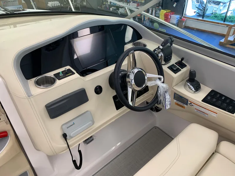 Slide: The Image of 2021 Regal 33 Express boat helm with steering wheel and control panel. - 30