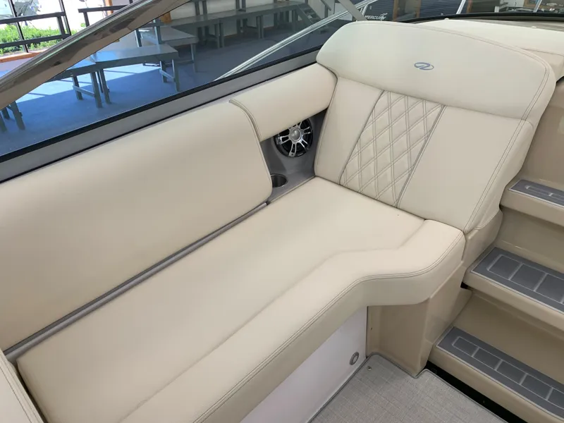 Slide: The Image of 2021 Regal 33 Express boat interior with beige seating and diamond stitching. - 31