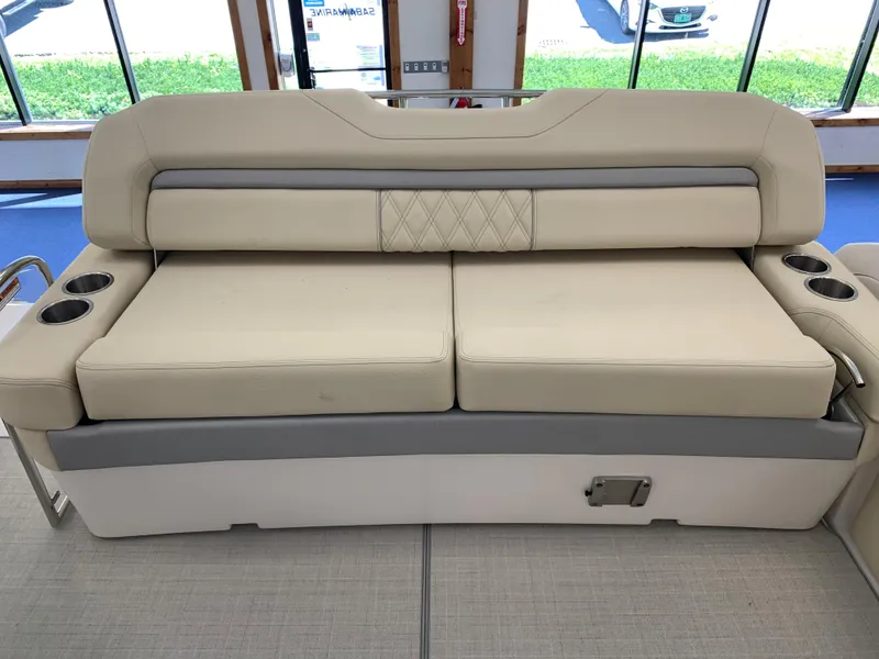 Slide: The Image of 2021 Regal 33 Express boat interior with beige cushioned seating and cup holders. - 34