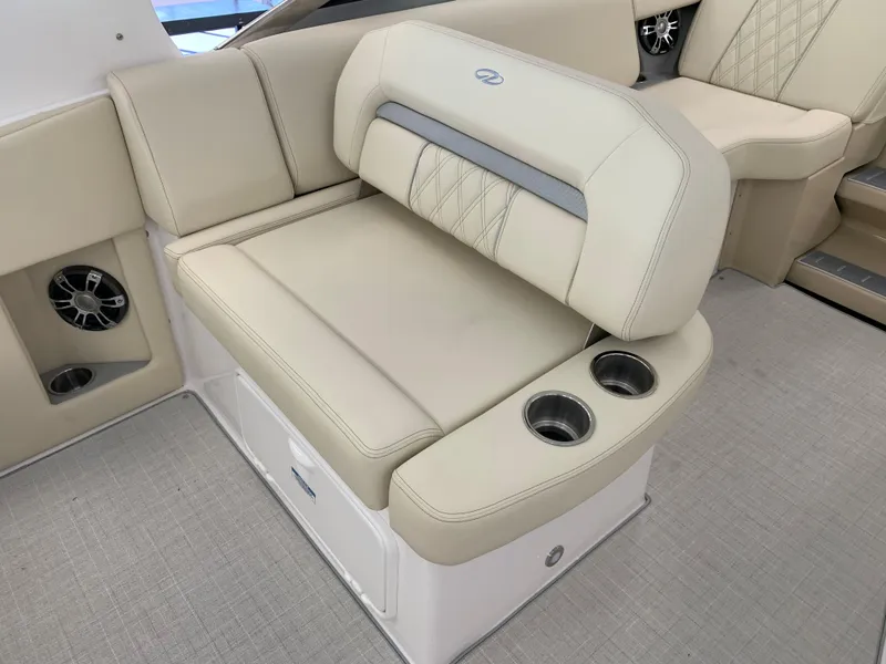 Slide: The Image of 2021 Regal 33 Express boat interior with beige seating and cup holders. - 35
